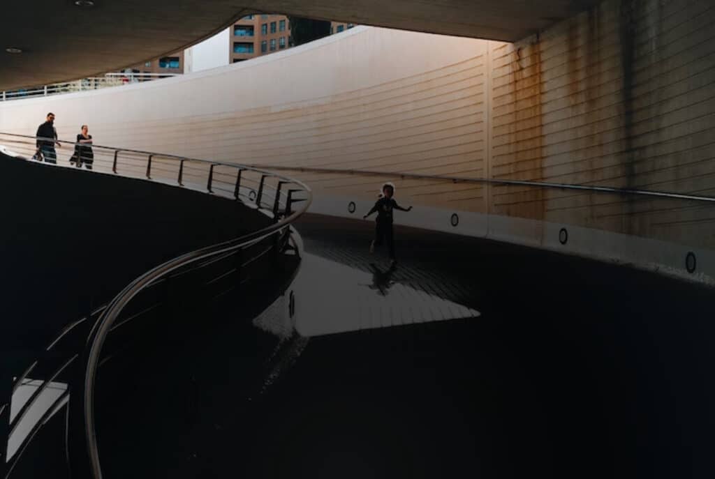 A family travel down an underpass
